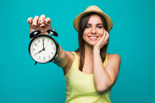 Smiling beauty woman holding alarm watch at 8 oclock. Isolated portrait. - Foto, immagini