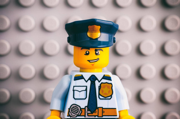 Portrait of Lego policeman minifigure with Lego gray baseplate b - Fotoğraf, Görsel