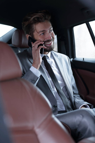 businessman talking on the phone in the back - Photo, image