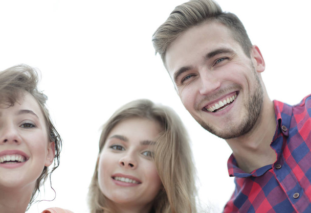 closeup of three young people smiling on white background - Foto, Bild