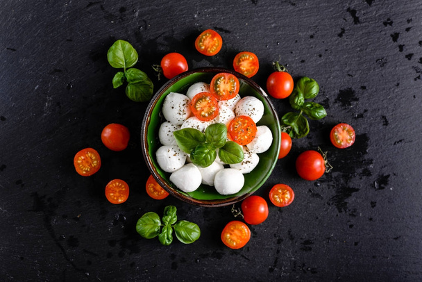 Tomatoes and mozzarella, italian food background, top view - Foto, Imagen