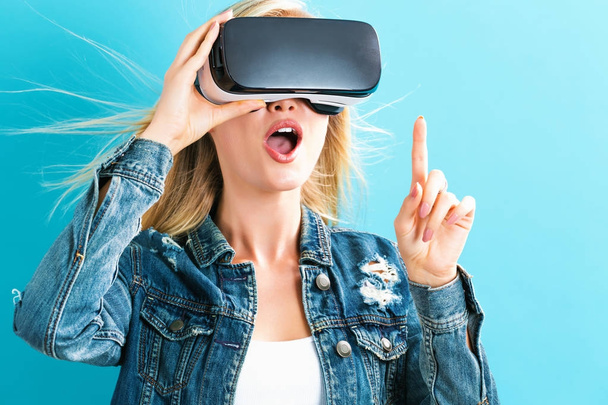 Young woman using virtual reality headset - Photo, image