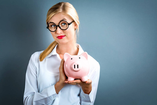  Young woman with a piggy bank - Photo, Image