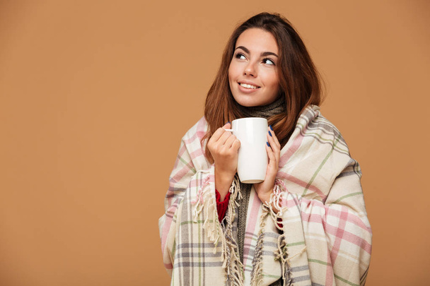 Portrait of a lovely young girl covered in blanket - Foto, afbeelding