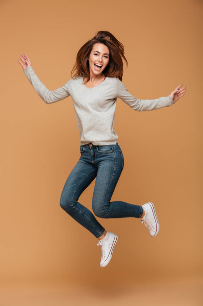 Full length photo of charming young woman in casual wear jumping - Photo, image