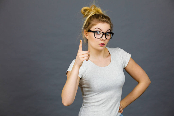 Woman wearing eyeglasses pointing at camera - Фото, изображение