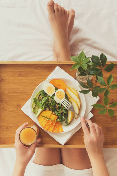 Healthy eating concept. Woman having breakfast in bed. Top view. - Fotografie, Obrázek