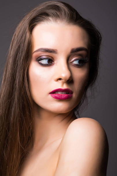 Beautiful woman with professional make up on dark background - Valokuva, kuva