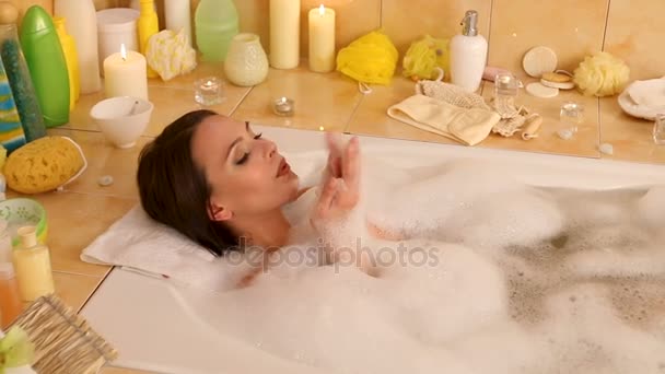 Bubble bath for woman taking , blow on foam . Dolly system. - Footage, Video