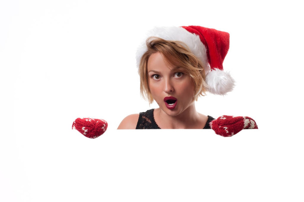 Christmas. Beautiful woman wear santa hat and mittens - Zdjęcie, obraz