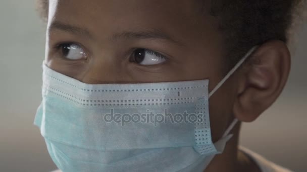 African boy wearing medical mask and looking at camera, infection, healthcare - Felvétel, videó