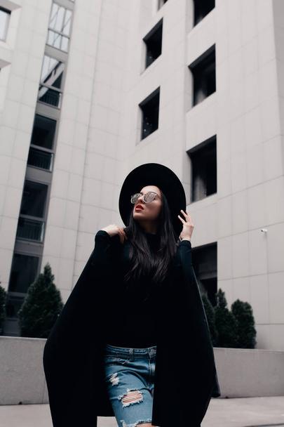 Fashion portrait of pretty young model dressed in black coat, st - Photo, Image