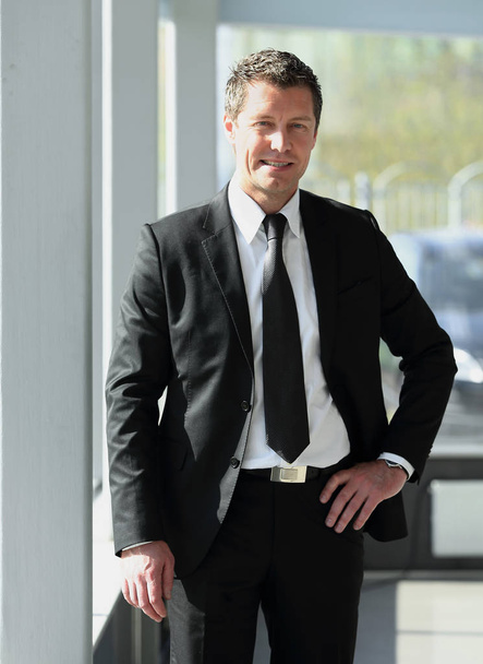 portrait of confident businessman on blurred background - Fotó, kép