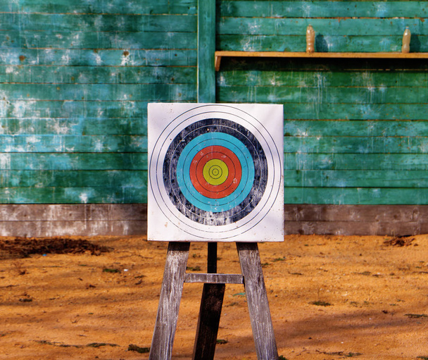 Primer plano del objetivo de tiro con arco sobre fondo de tablas de madera verde
 - Foto, imagen