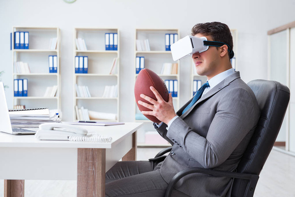 Businessman playing virtual reality football in office with VR g - Valokuva, kuva
