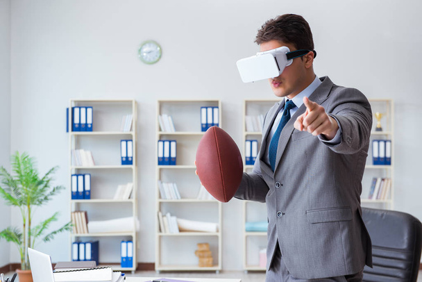 Businessman playing virtual reality football in office with VR g - Foto, Imagen