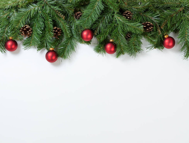 Christmas red ornaments hanging in fir tree branches  - Foto, Imagem