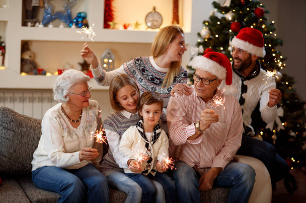 season, elderly, gifts, holiday and people-family with sprinkler - Φωτογραφία, εικόνα