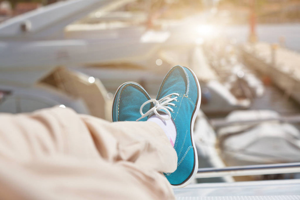 Human legs in pants and bright blue topsiders on yacht - Foto, Imagem