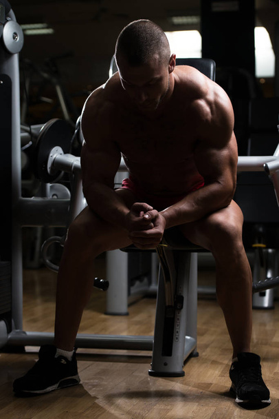 Attractive Young Man Resting In Gym Afther Exercise - Foto, afbeelding