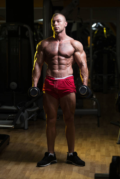 Man With Dumbbells Exercising Biceps - 写真・画像