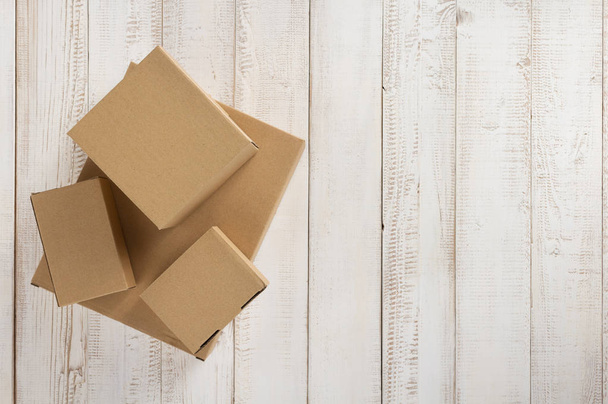 cardboard box on wooden background - Фото, зображення