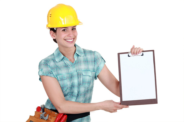 Woman pointing to clip-board - Photo, Image