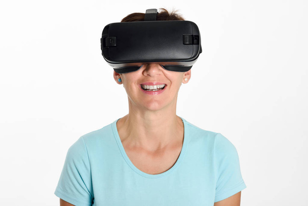 Woman looking in VR glasses and gesturing with his hands. - Photo, Image