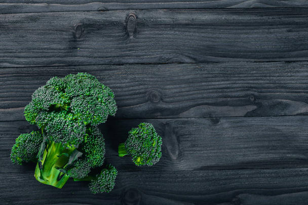 Brocoli on a wooden surface. Top view. Free space for text. - Fotó, kép
