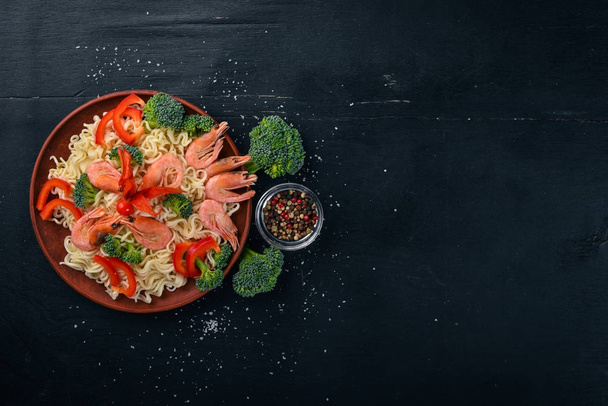Asian food with seafood and vegetables. Shrimp, broccoli, paprika, spices. Top view. Free space for text. - Foto, Imagem