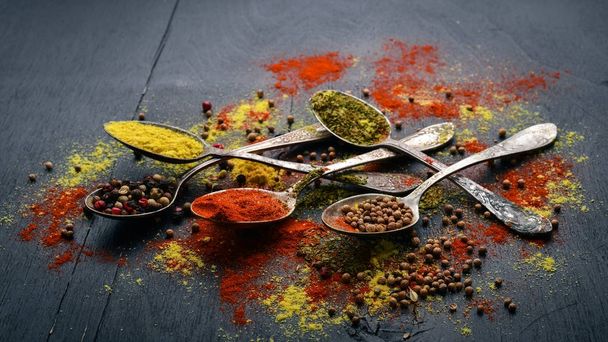 Spices and herbs. A large assortment of spices. Indian cuisine. On the wooden table. Top view. Free space for text. - Photo, image