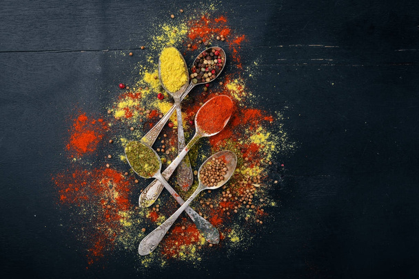 Spices and herbs. A large assortment of spices. Indian cuisine. On the wooden table. Top view. Free space for text. - Foto, imagen