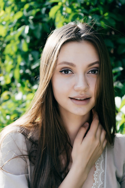 attractive beautiful girl with long hair posing, looking at camera and smiling - Zdjęcie, obraz