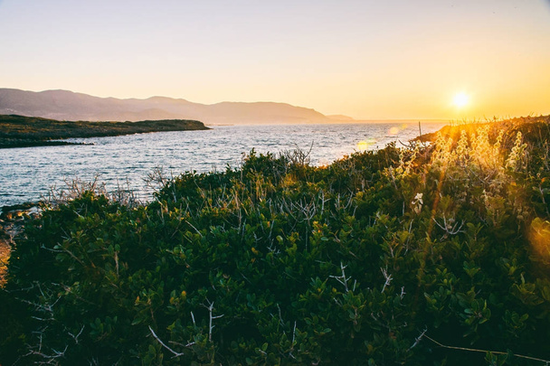 Gorgeous sunset on the coast of Crete - Фото, изображение