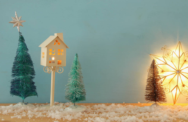 Image of christmas trees on snowy wooden table. - Φωτογραφία, εικόνα