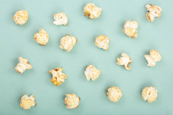 Popcorn on green background. Top view. Flat lay pattern - Photo, Image