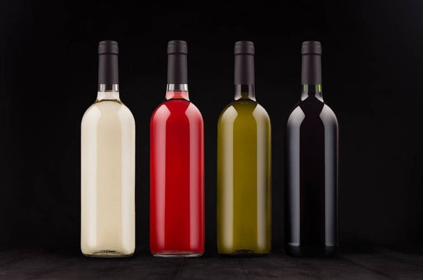 Wine bottles collection different colors, mock up on elegant dark black wooden background.  - Φωτογραφία, εικόνα