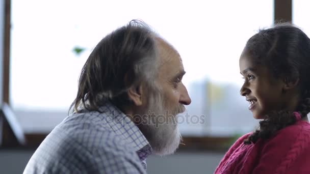 Loving granddad bonding cute granddaughter at home - Felvétel, videó