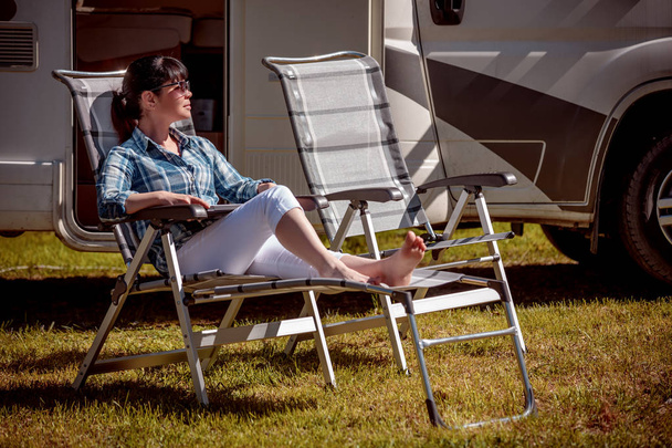 Woman resting near motorhomes in nature. Family vacation travel, - Fotoğraf, Görsel