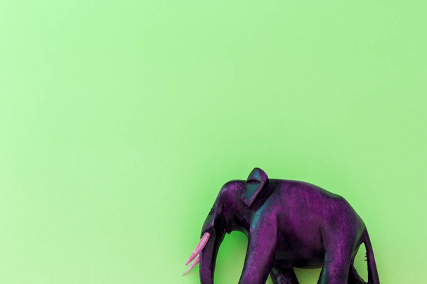 Wooden elephant on green background - Photo, Image