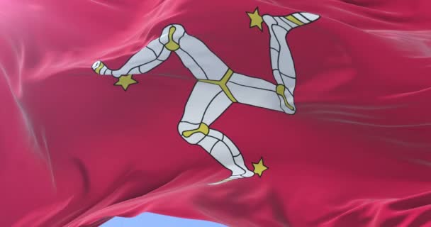 Flag of the Isle of Man waving at wind with blue sky in slow, loop - Footage, Video