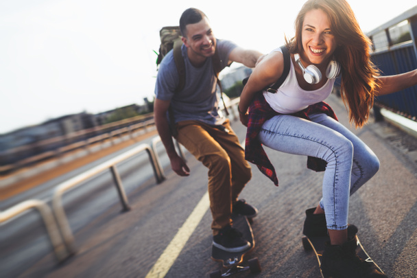 attractive couple riding skateboards  - Foto, Imagem