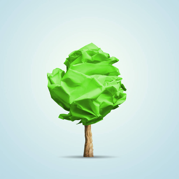Green crumpled paper shaped in tree. Conceptual image - Фото, изображение