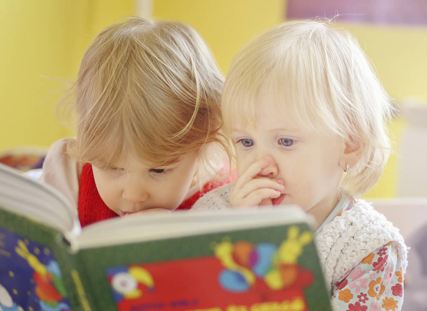 Two children reading book indoor - Photo, Image