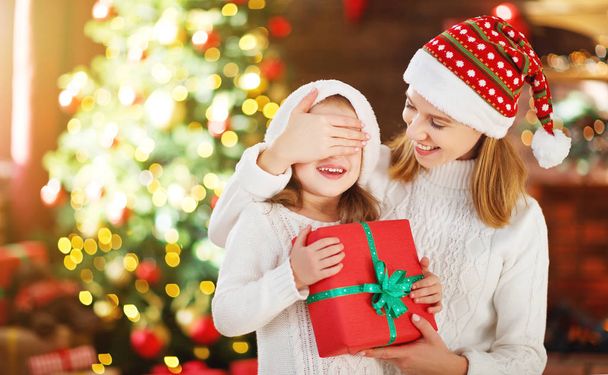 happy family mother and daughter giving christmas gift  - Foto, imagen