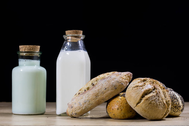 Ingredients, for breakfast. Milk in a bottle and bread on a kitc - Foto, Bild