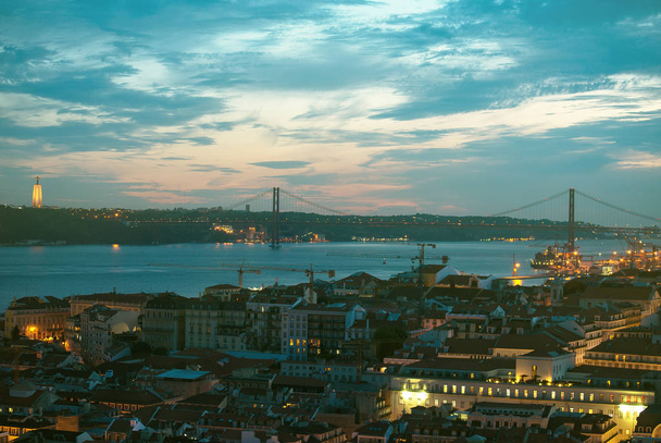 Alfama au centre-ville et le pont du 25 avril à Lisbonne le soir
. - Photo, image