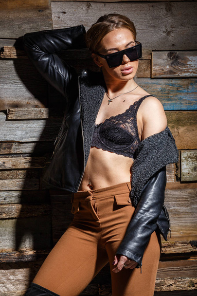 stylish girl in bra, jacket and sunglasses - Fotó, kép