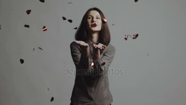 Young woman catching paper hearts over white. Slow motion - Metraje, vídeo