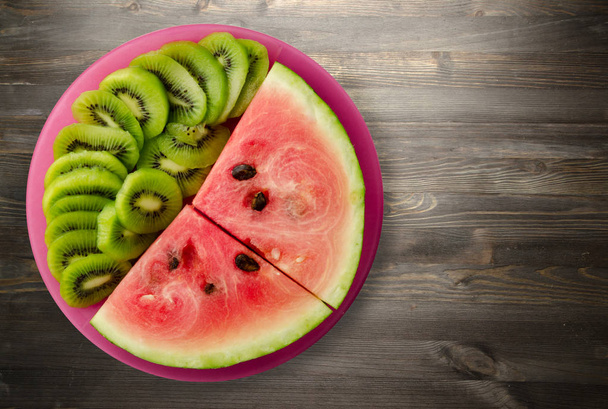 watermelon and kiwi sliced on a plate   - Фото, зображення